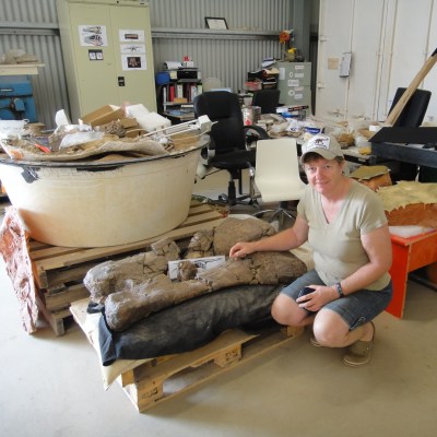 Rose Siva with sauropod bone at Winton, Queensland